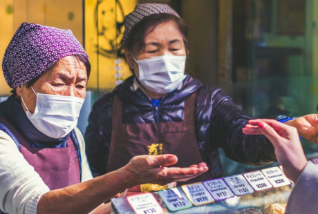 Vendedoras usam máscaras em um mercado de alimentos no Japão. Foto: Unsplash/Jérémy Stenuit